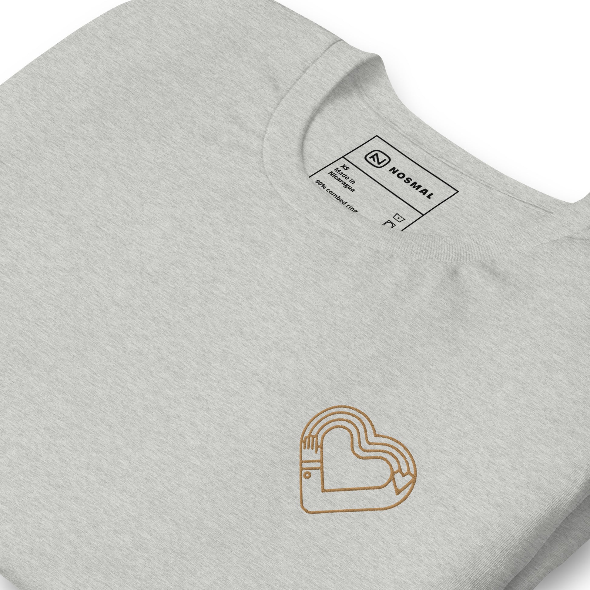 Angled close up maker's heart II gold embroidered design on heather athletic grey unisex t-shirt.