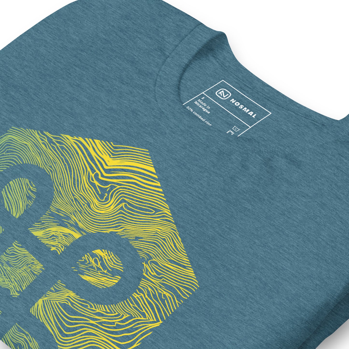 Angled close up shot of the commander gradient design on heather deep teal unisex t-shirt.