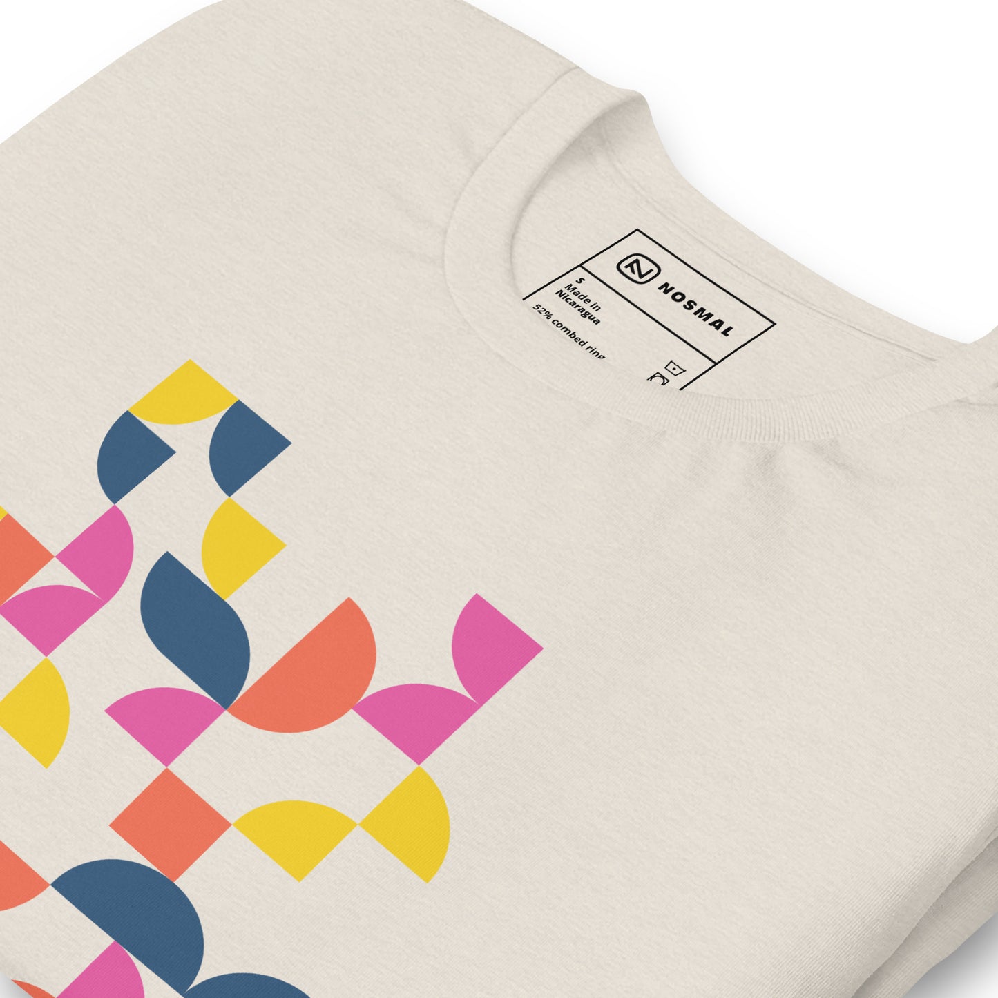 Angled close up shot of geometria I sunrise design on heather dust unisex t-shirt.