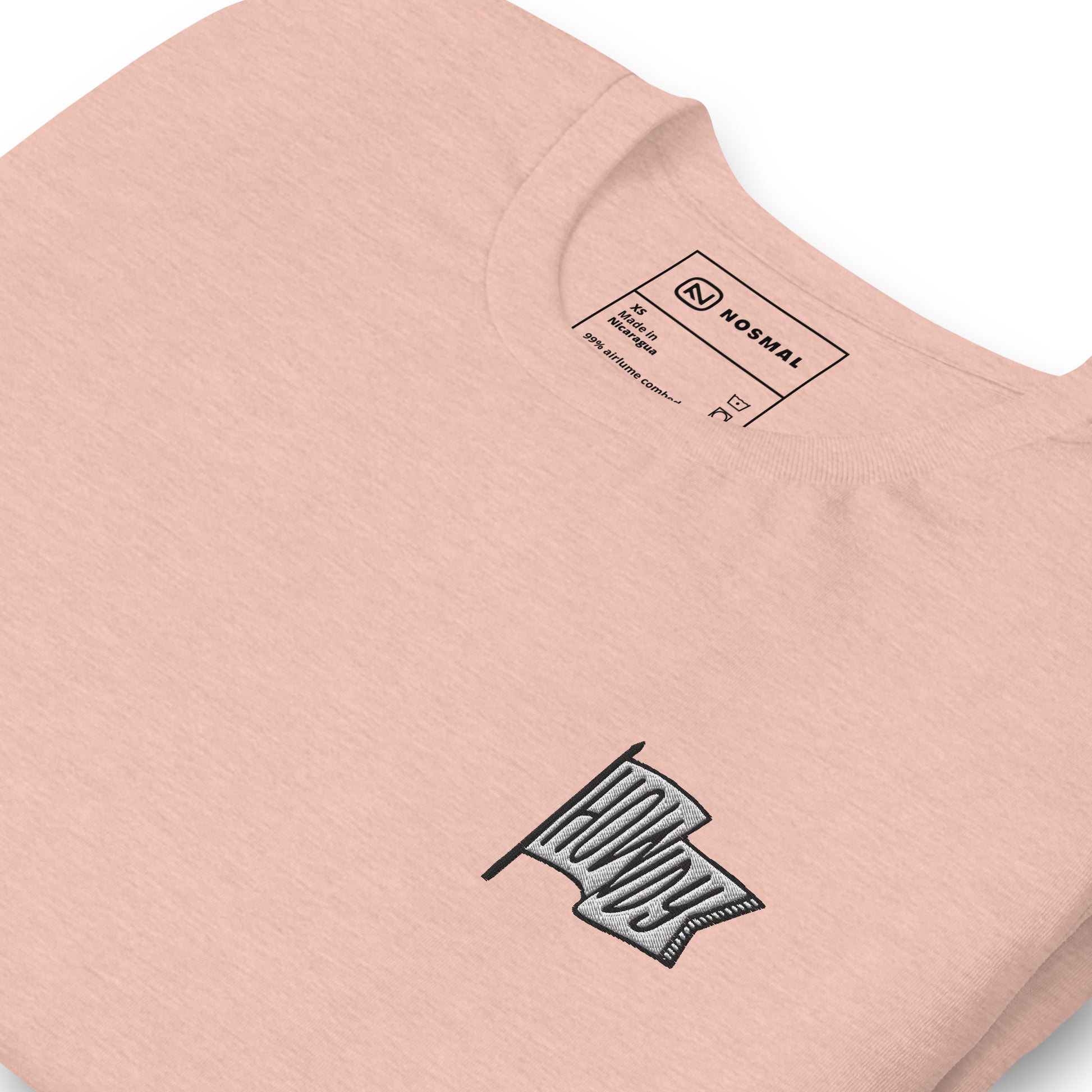 Angled close up howdy embroidered design on heather prism peach unisex t-shirt.