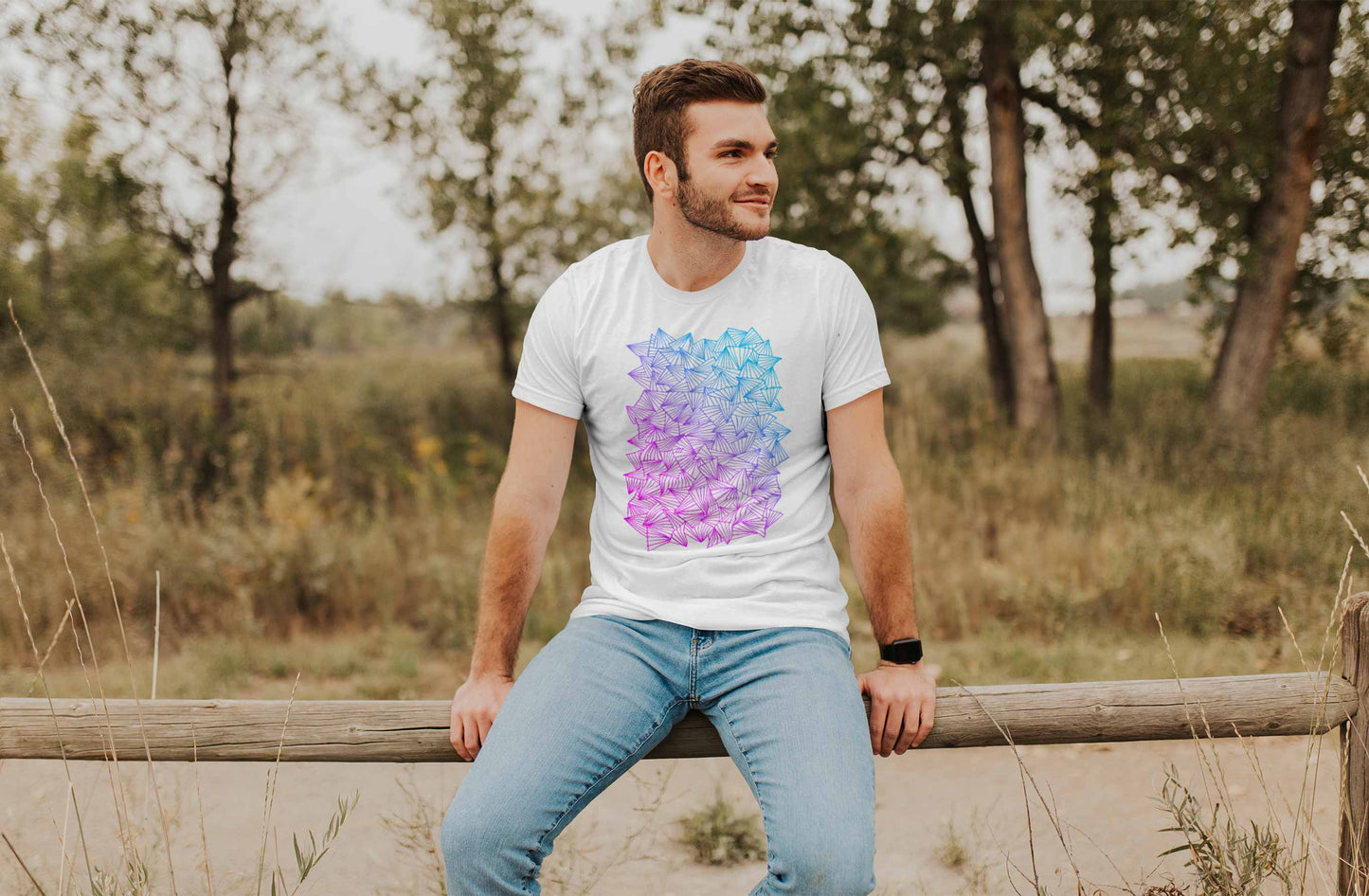 Model posing in a field with gaggle of triangles gradient design on white unisex t-shirt.
