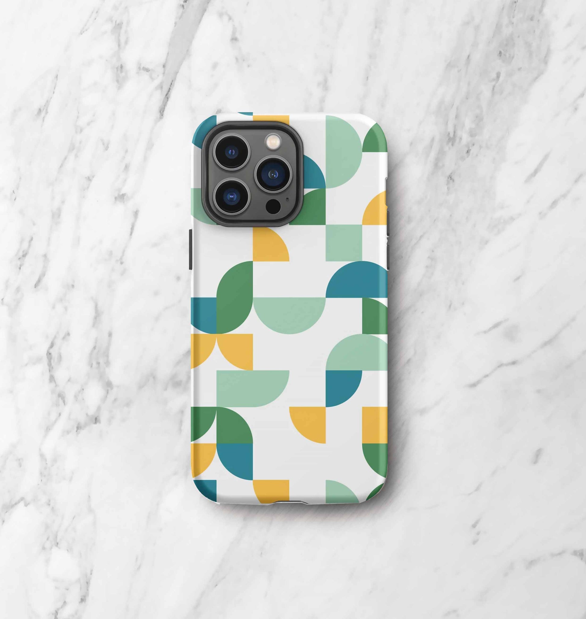 Front view of iPhone tough case in Geometria I Midday design on a marble countertop