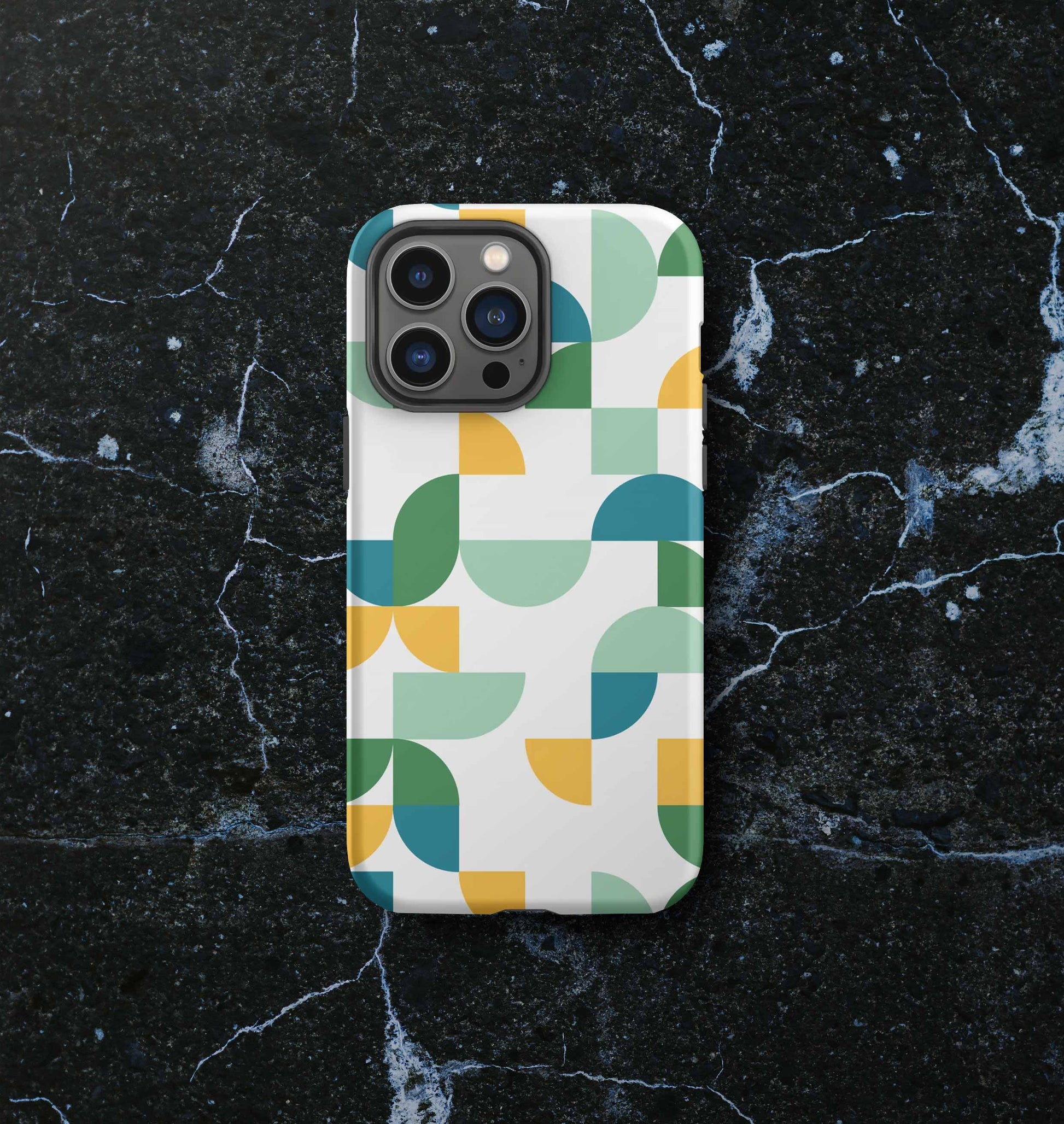 Front view of iPhone tough case in Geometria I Midday design on a slate countertop
