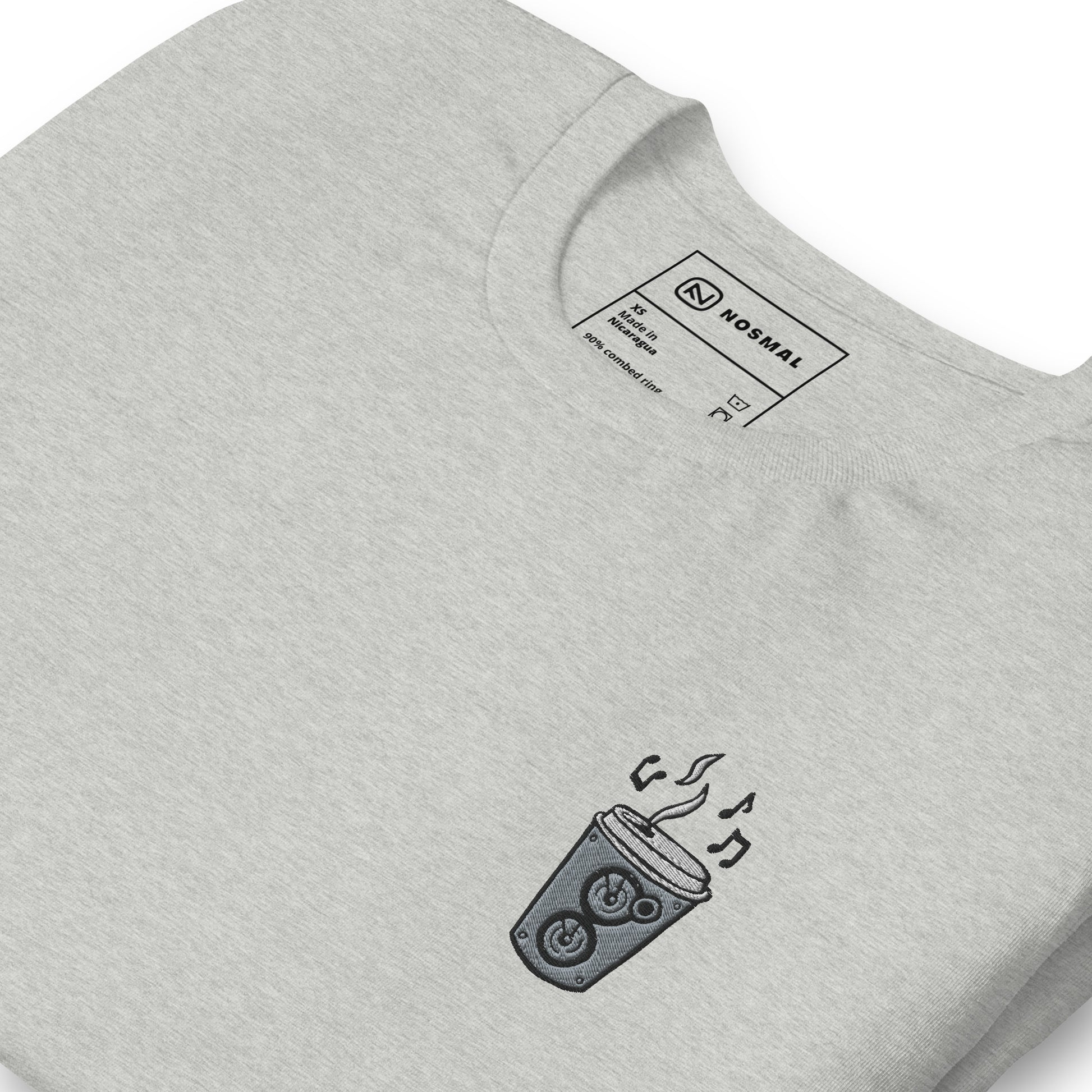 Angled close up shot of the coffee is my jam embroidered design on heather athletic grey unisex t-shirt.