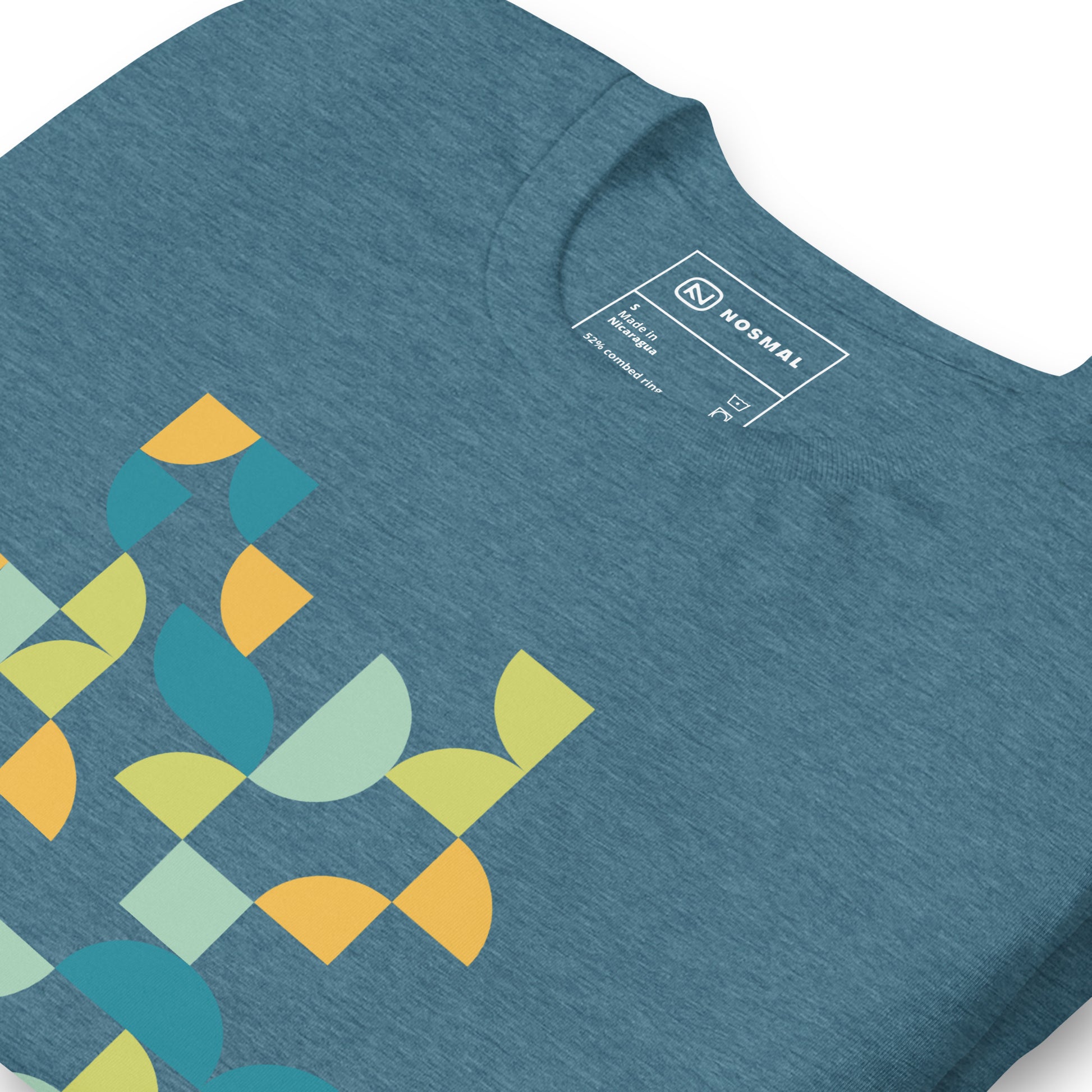 Angled close up shot of geometria I midday design on heather deep teal unisex t-shirt.