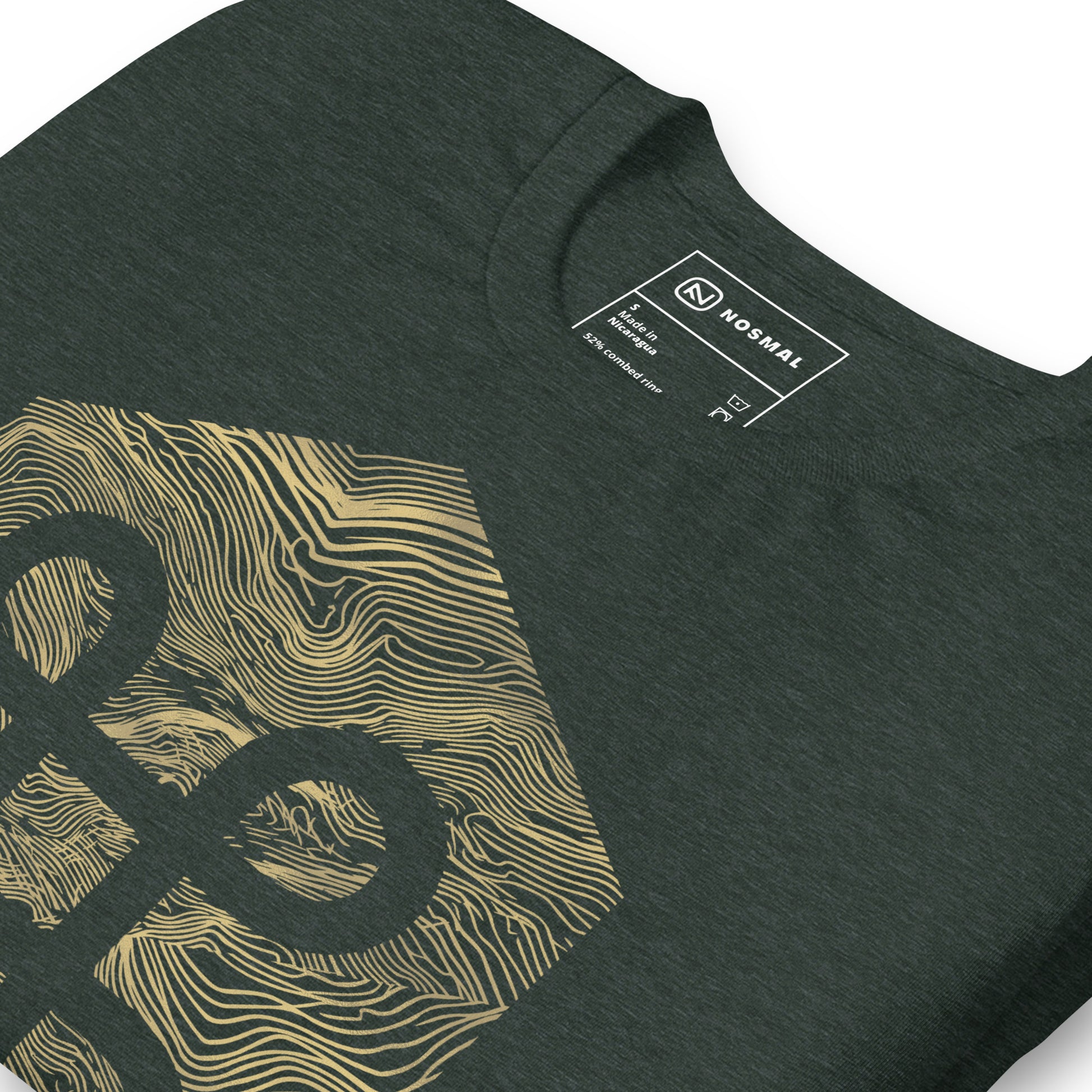 Angled close up shot of the commander gold design on heather forest unisex t-shirt.