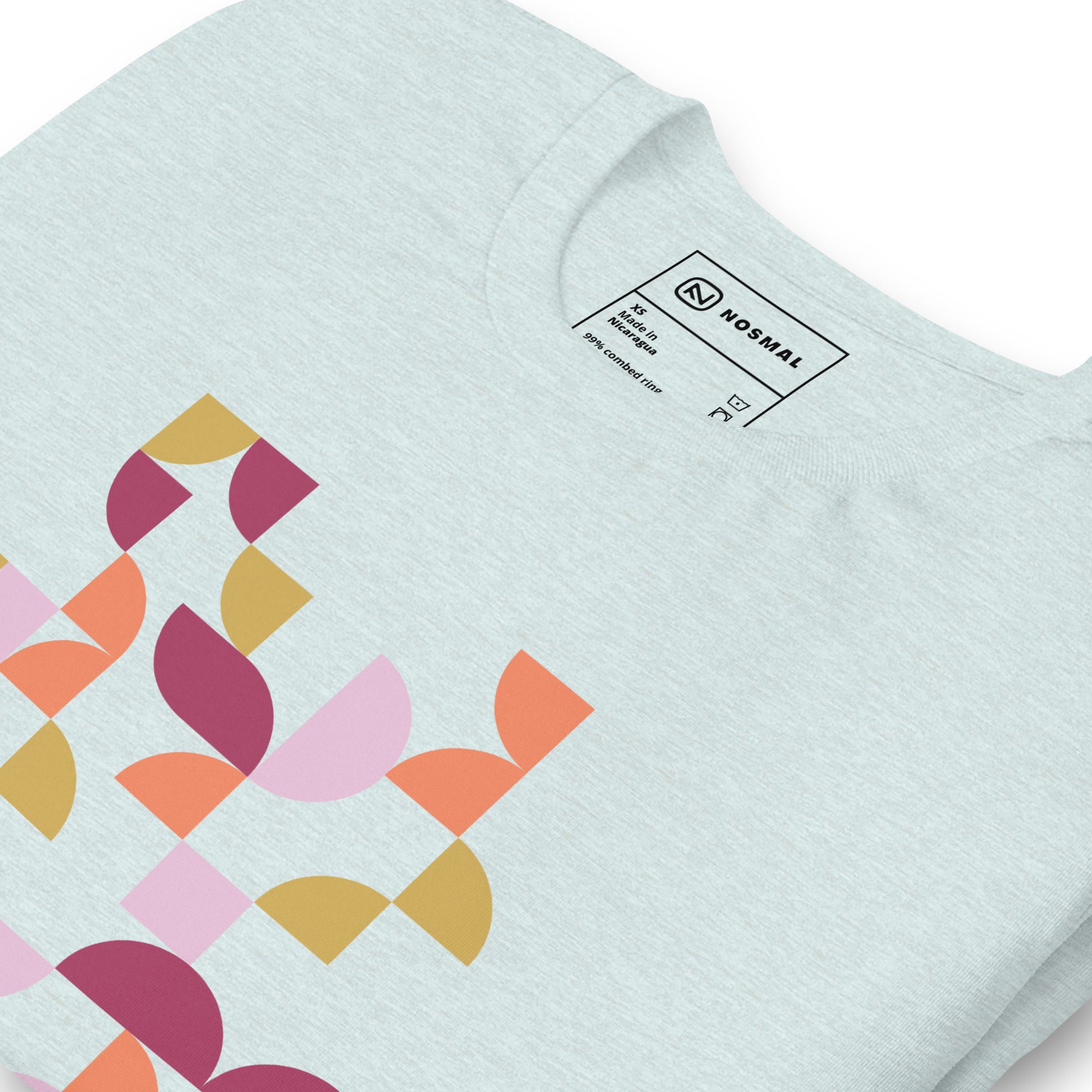 Angled close up shot of geometria I sunset design on heather prism ice blue unisex t-shirt.